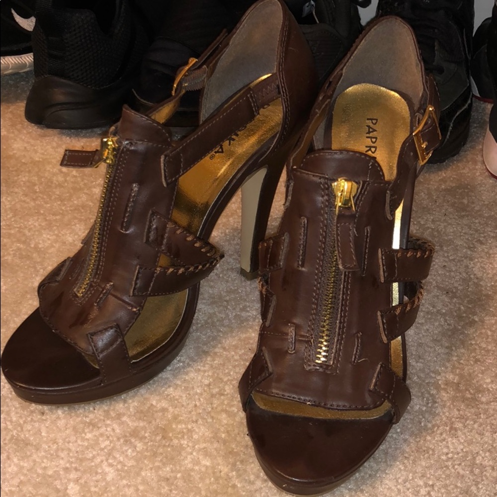 Chocolate brown heels with gold zipper detailing.